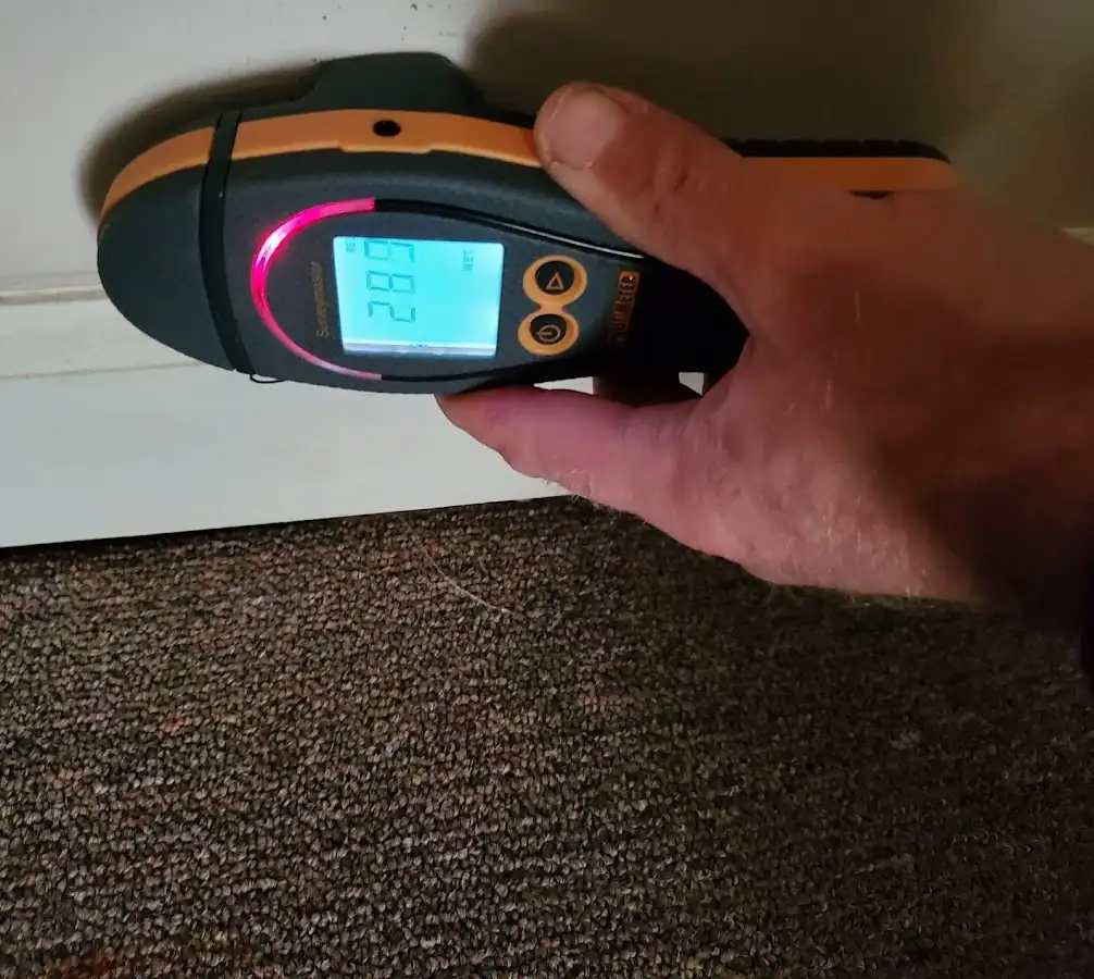Moisture detection at baseboard during Storm Damage Restoration in Arvin